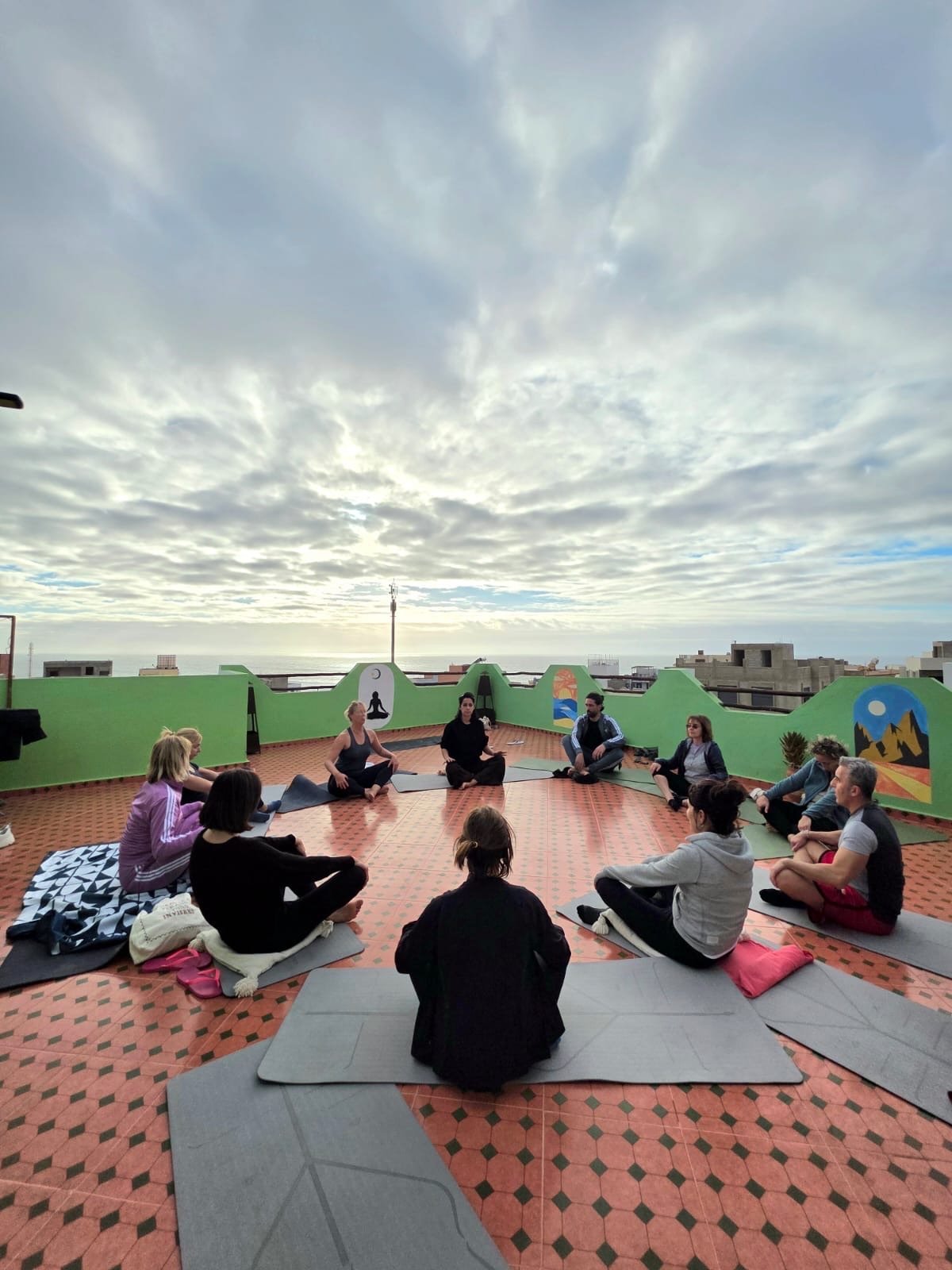 Yoga class on Dar Mouja rooftop terrace at sunrise